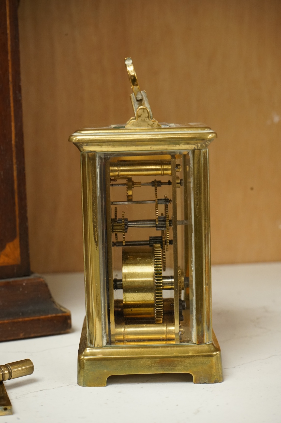 An early 20th century inlaid mantel clock with key and pendulum and a brass cased carriage timepiece, largest 32cm high